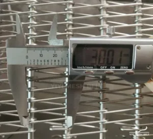 YIYI Mesh Belt self-stacking belt rod pitch measured with a digital caliper while a customer sample is turned into a drawing